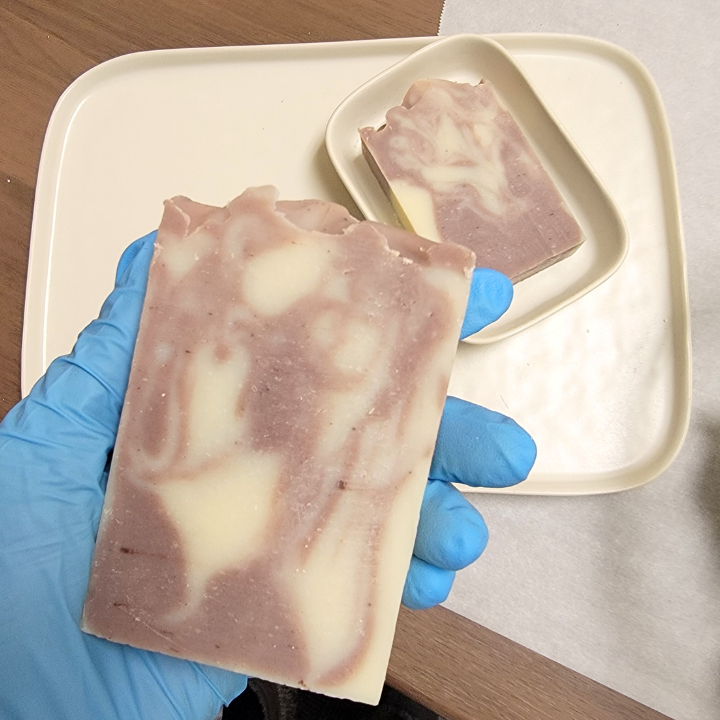 Elevate your self-care routine with Lavender Silk Handmade Soap, a luxurious floral-infused bar made with hydrating aloe vera, kaolin clay, and nourishing plant-based oils. The tranquil scent of lavender, ylang ylang, and cedarwood promotes relaxation, while silk fibers enhance lather for a spa-like experience. Handcrafted in small batches, this soap provides a soothing cleanse for all skin types.