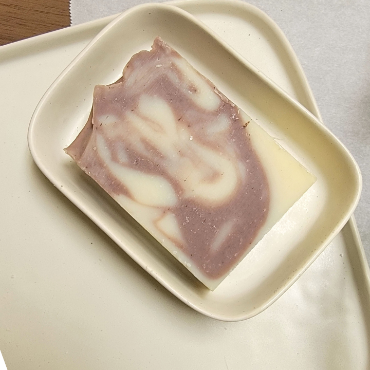 Experience the tranquil beauty of nature with Lavender Silk Handmade Soap, a delicate fusion of lavender, ylang ylang, and cedarwood essential oils. This floral-scented bar is enriched with silk fibers, aloe vera, and kaolin clay, providing deep hydration, gentle cleansing, and a rich, creamy lather. Infused with purple clay and alkanet root, it naturally enhances skin clarity while adding a soft, earthy hue.