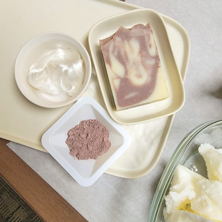 Lavender Silk Natural Handmade Soap is a calming, nourishing soap crafted with skin-loving ingredients and a serene floral aroma. Made in small batches using traditional soap-making methods, this luxurious bar provides a gentle, soothing cleanse without stripping or drying your skin.
Infused with a tranquil essential oil blend of lavender, ylang ylang, and cedarwood, this soap offers a naturally relaxing scent that promotes a sense of peace and well-being. Purple clay and alkanet root lend a soft, natural